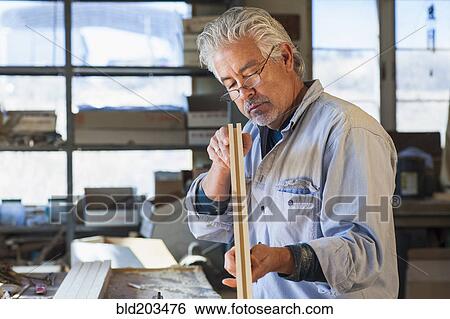 Stock Photograph - Hispanic craftsman working in studio. Fotosearch