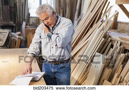 Stock Photography - Hispanic craftsman working in studio. Fotosearch
