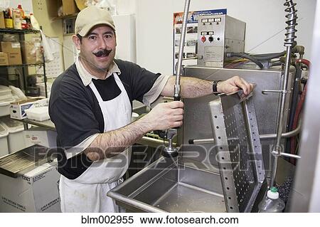 Hispanic dishwasher in commercial kitchen View Large Photo Image Stock Photography - Hispanic dishwasher in commercial kitchen. Fotosearch