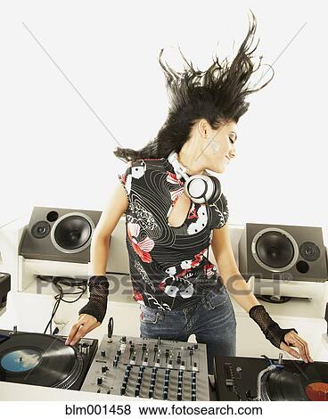 Stock Photo - Hispanic dj with turntable and sound mixer. Fotosearch