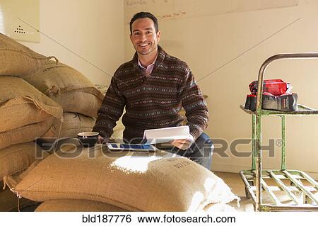 Hispanic entrepreneur using digital tablet in store View Large Photo Image Stock Photograph - Hispanic entrepreneur using digital tablet in store. Fotosearch