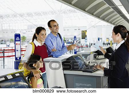 Stock Photo - Hispanic family checking in at airport. Fotosearch