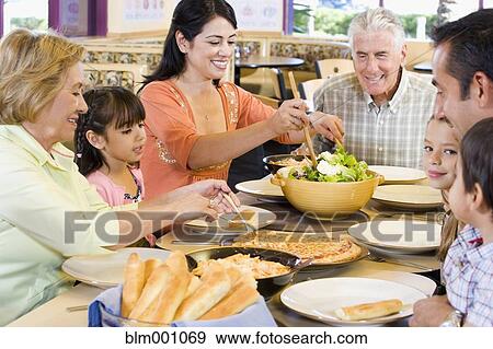 Hispanic family eating dinner together View Large Photo Image Stock Photo - Hispanic family eating dinner together. Fotosearch
