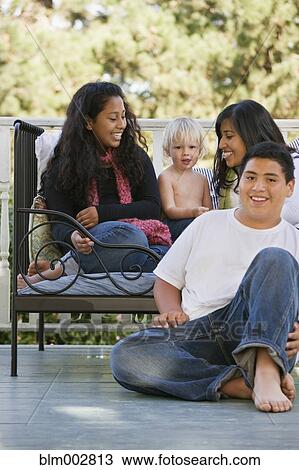 Hispanic family sitting on porch View Large Photo Image Stock Image - Hispanic family sitting on porch. Fotosearch