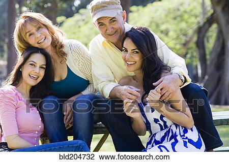 Stock Image - Hispanic family smiling outdoors. Fotosearch