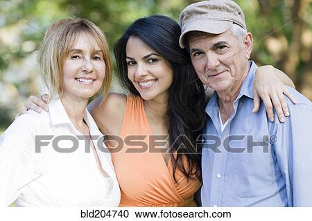 Stock Image - Hispanic family smiling outdoors. Fotosearch