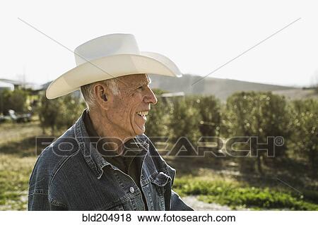 Hispanic farmer smiling in vineyard View Large Photo Image Stock Photo - Hispanic farmer smiling in vineyard. Fotosearch