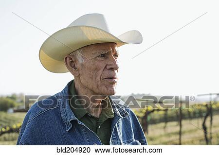 Hispanic farmer standing in vineyard View Large Photo Image Stock Image - Hispanic farmer standing in vineyard. Fotosearch