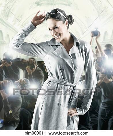 Stock Image - Hispanic female celebrity posing for photographers. Fotosearch