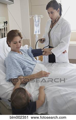 Hispanic female doctor examining patient View Large Photo Image Stock Image - Hispanic female doctor examining patient. Fotosearch