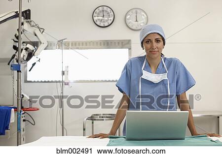 Stock Image - Hispanic female medical professional with laptop. Fotosearch