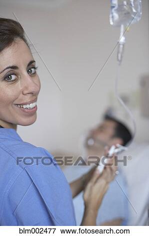 Hispanic female medical professional injecting IV View Large Photo Image Stock Photo - Hispanic female medical professional injecting IV. Fotosearch