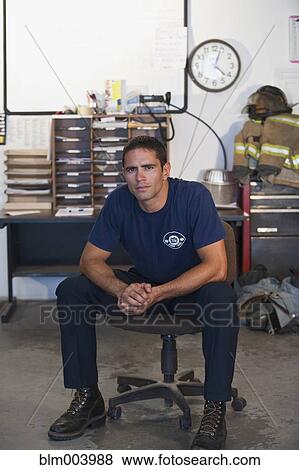 Hispanic fireman sitting in office View Large Photo Image Stock Photo - Hispanic fireman sitting in office. Fotosearch