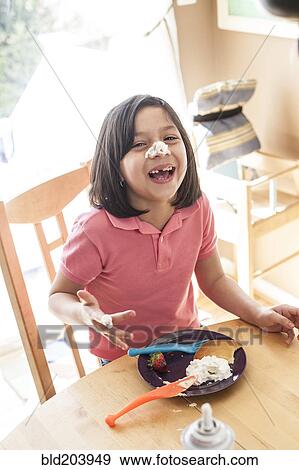 Hispanic girl playing with food at table View Large Photo Image Stock Photo - Hispanic girl playing with food at table. Fotosearch