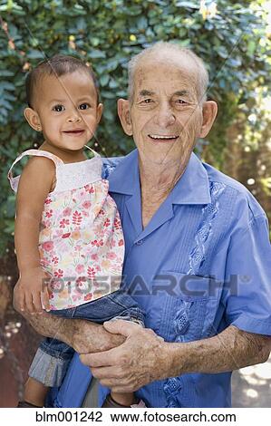 Hispanic grandfather holding granddaughter View Large Photo Image Stock Image - Hispanic grandfather holding granddaughter. Fotosearch