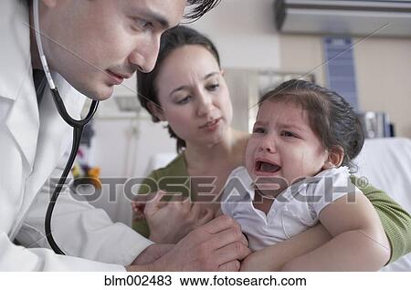 Hispanic male doctor examining crying baby View Large Photo Image Stock Image - Hispanic male doctor examining crying baby. Fotosearch