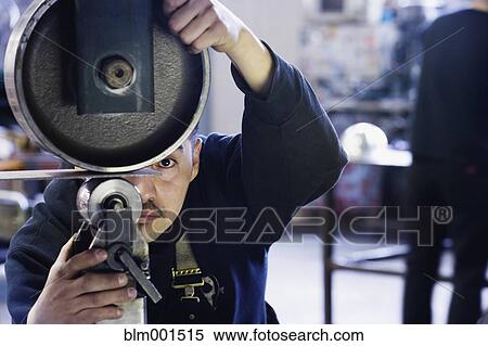 Stock Photography - Hispanic male metalworker in shop . Fotosearch