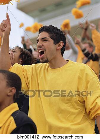 Hispanic man cheering at sporting event View Large Photo Image Stock Image - Hispanic man cheering at sporting event. Fotosearch
