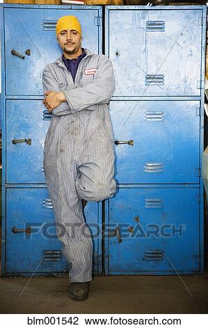 Hispanic man in coveralls leaning on metal lockers View Large Photo Image Stock Image - Hispanic man in coveralls leaning on metal lockers. Fotosearch