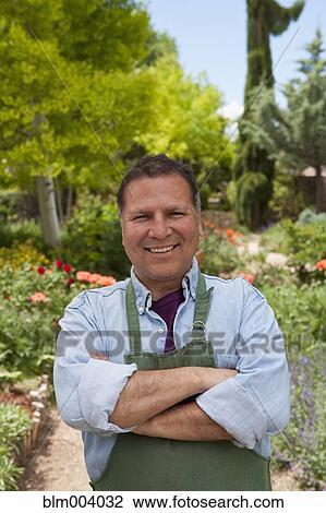 Hispanic man standing with arms crossed in garden View Large Photo Image Stock Image - Hispanic man standing with arms crossed in garden. Fotosearch