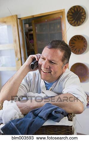 Stock Image - Hispanic man talking on telephone. Fotosearch