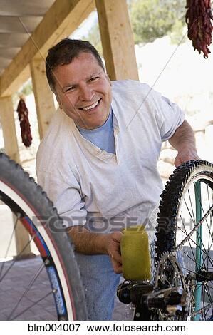 Hispanic man washing bicycle View Large Photo Image Stock Photo - Hispanic man washing bicycle. Fotosearch
