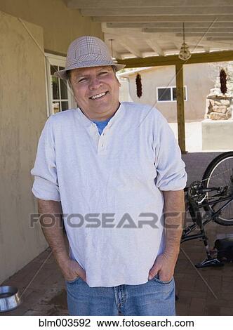 Stock Image - Hispanic man wearing fedora. Fotosearch