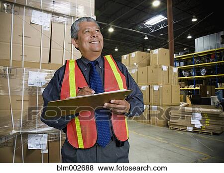 Hispanic man working in warehouse View Large Photo Image Stock Photo - Hispanic man working in warehouse. Fotosearch