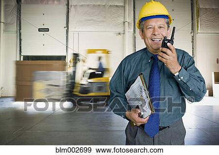 Hispanic man working in warehouse View Large Photo Image Stock Photo - Hispanic man working in warehouse. Fotosearch