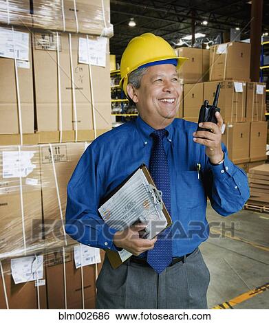 Hispanic man working in warehouse View Large Photo Image Stock Photograph - Hispanic man working in warehouse. Fotosearch