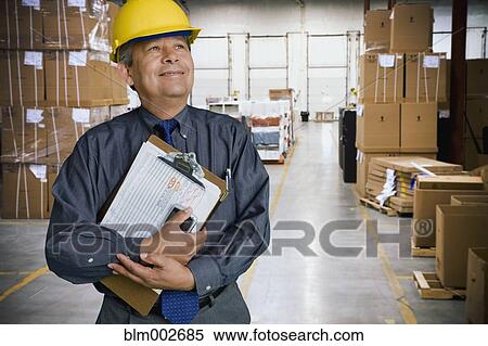 Hispanic man working in warehouse View Large Photo Image Stock Photography - Hispanic man working in warehouse. Fotosearch