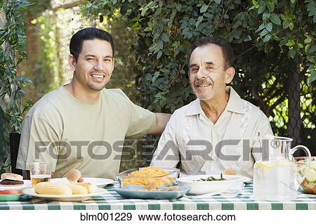 Hispanic men eating outdoors View Large Photo Image Stock Photo - Hispanic men eating outdoors. Fotosearch