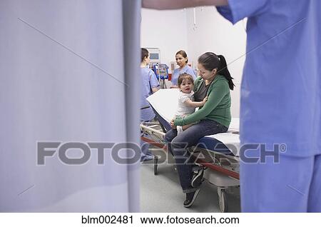 Stock Image - Hispanic mother and baby at hospital. Fotosearch