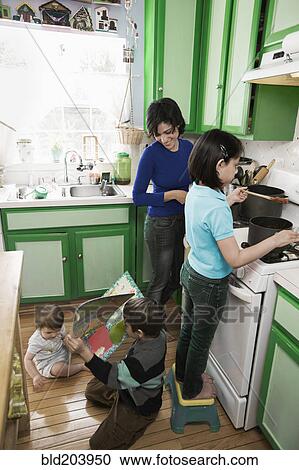 Hispanic mother and children in kitchen View Large Photo Image Stock Image - Hispanic mother and children in kitchen. Fotosearch