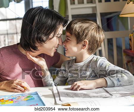 Picture - Hispanic mother and son touching noses. Fotosearch
