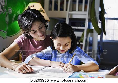 Hispanic mother helping daughter with homework View Large Photo Image Stock Photography - Hispanic mother helping daughter with homework. Fotosearch