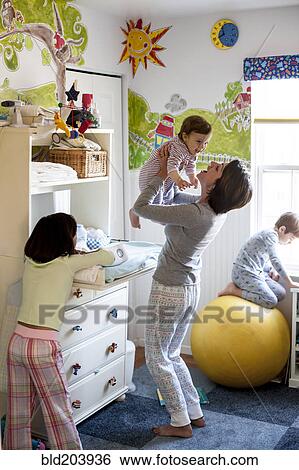 Hispanic mother with children in bedroom View Large Photo Image Stock Photograph - Hispanic mother with children in bedroom. Fotosearch