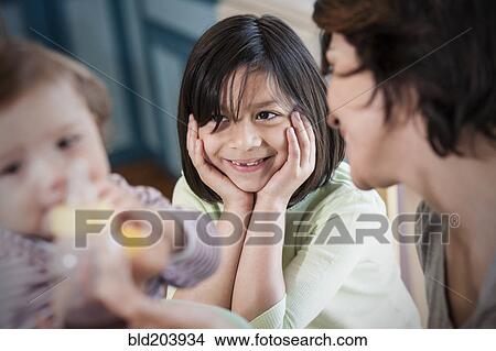 Hispanic mother with children in kitchen View Large Photo Image Picture - Hispanic mother with children in kitchen. Fotosearch