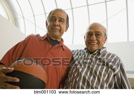 Stock Image - Hispanic senior men with basketball. Fotosearch