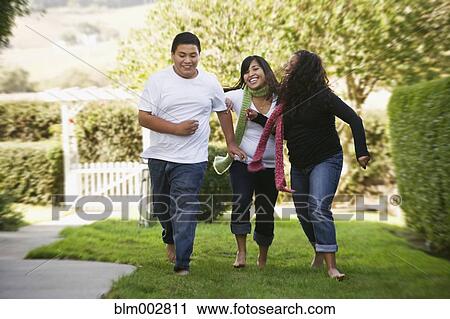 Hispanic siblings running on grass View Large Photo Image Stock Image - Hispanic siblings running on grass. Fotosearch