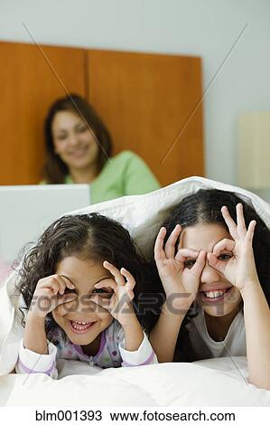 Hispanic sisters playing underneath blanket View Large Photo Image Stock Image - Hispanic sisters playing underneath blanket. Fotosearch