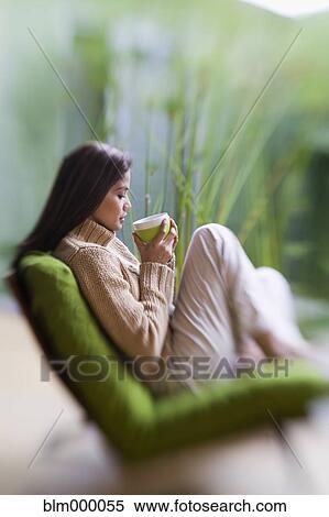 Stock Photography - Hispanic woman drinking coffee. Fotosearch