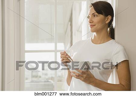 Hispanic woman eating from bowl View Large Photo Image Stock Photo - Hispanic woman eating from bowl. Fotosearch