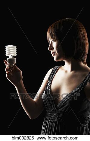 Hispanic woman holding energy efficient light bulb View Large Photo Image Stock Photography - Hispanic woman holding energy efficient light bulb. Fotosearch