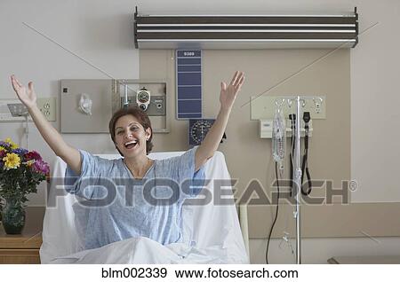 Hispanic woman in hospital bed with arms raised View Large Photo Image Stock Photo - Hispanic woman in hospital bed with arms raised. Fotosearch