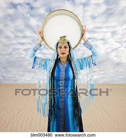 Stock Image - Hispanic woman in traditional Asian clothing. Fotosearch