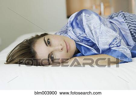 Hispanic woman laying on bed View Large Photo Image Stock Image - Hispanic woman laying on bed. Fotosearch