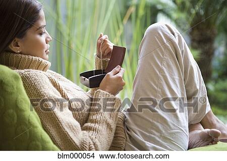Picture - Hispanic woman looking at jewelry. Fotosearch