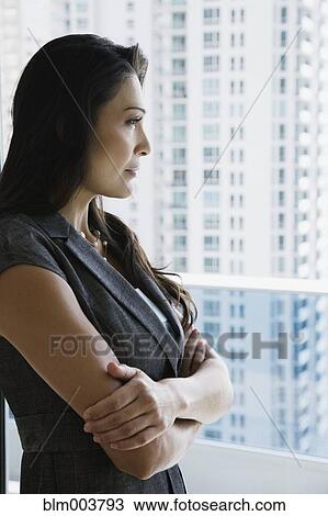 Hispanic woman looking out window View Large Photo Image Stock Image - Hispanic woman looking out window. Fotosearch