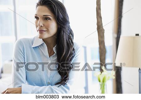 Stock Image - Hispanic woman looking pensive. Fotosearch